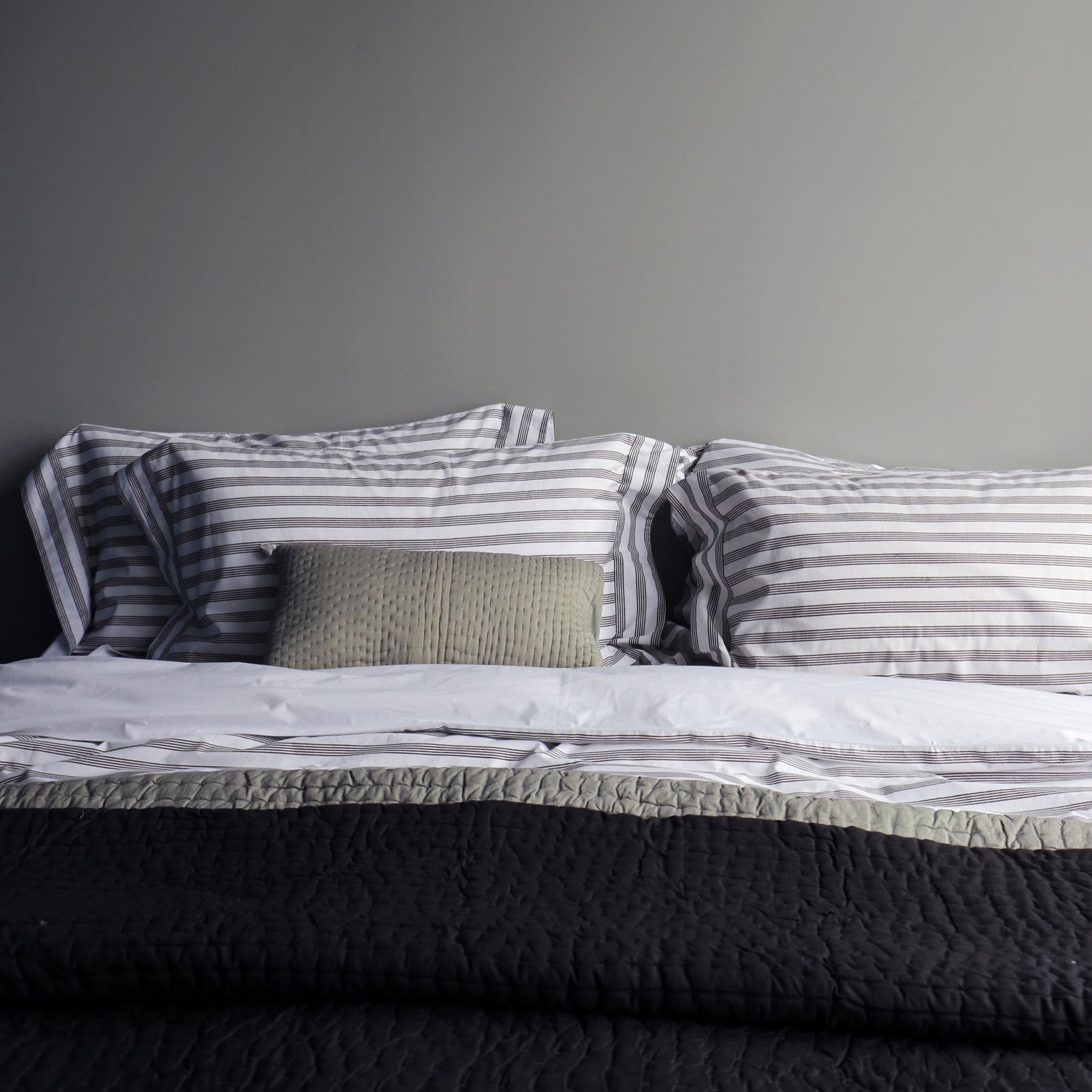 Grey pompom quilted cushion