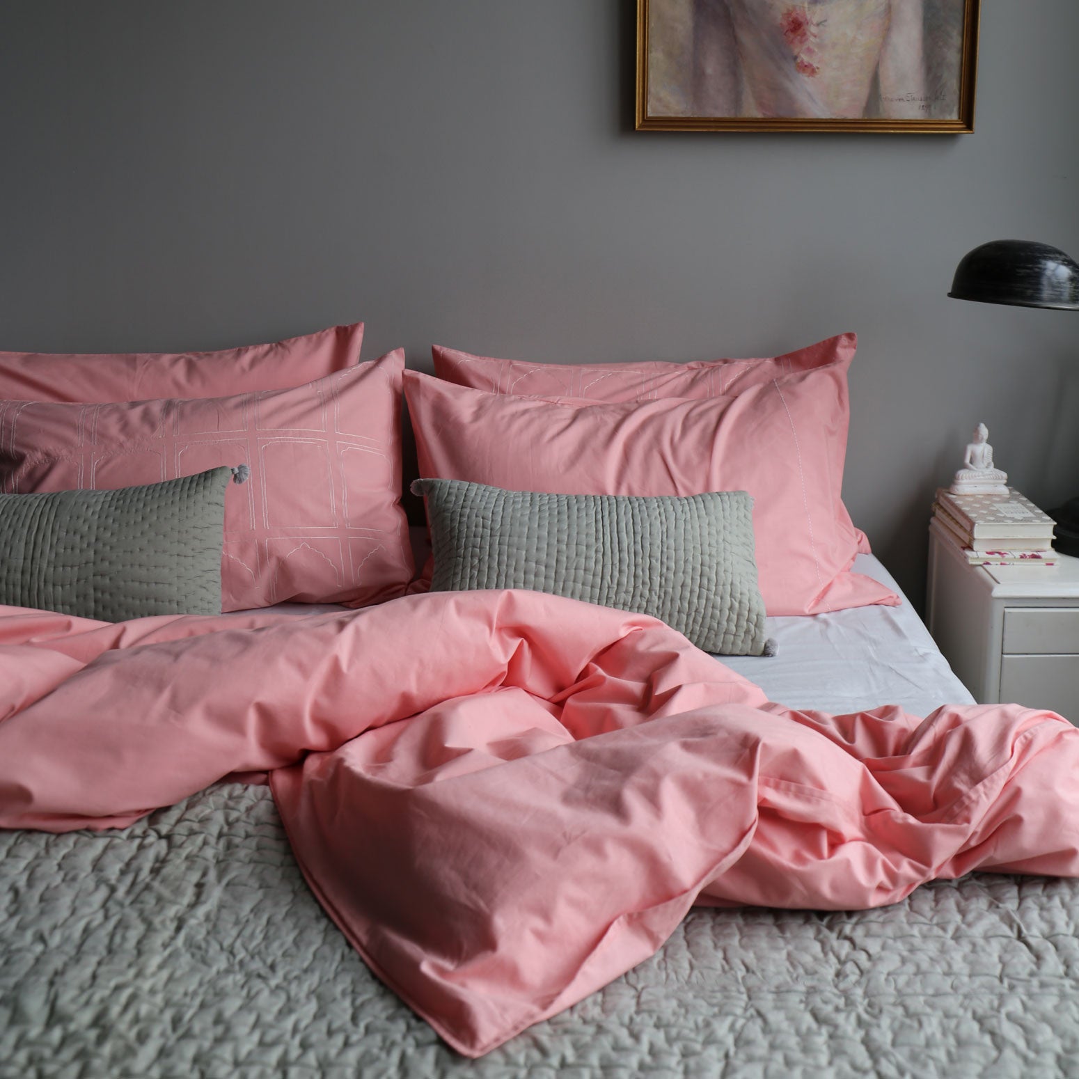 Grey pompom quilted cushion