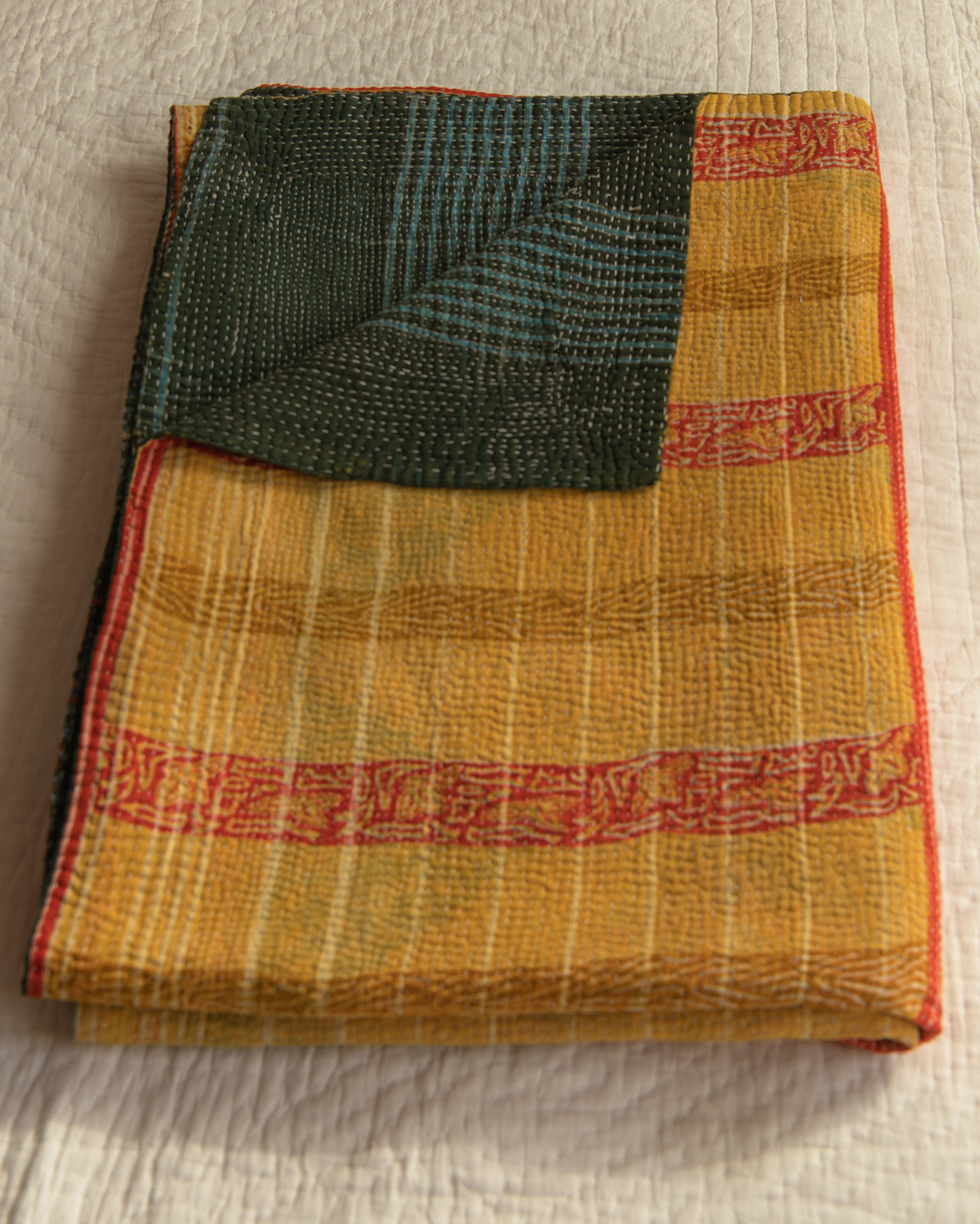 Orange Ikat with blue check reverse kantha quilt