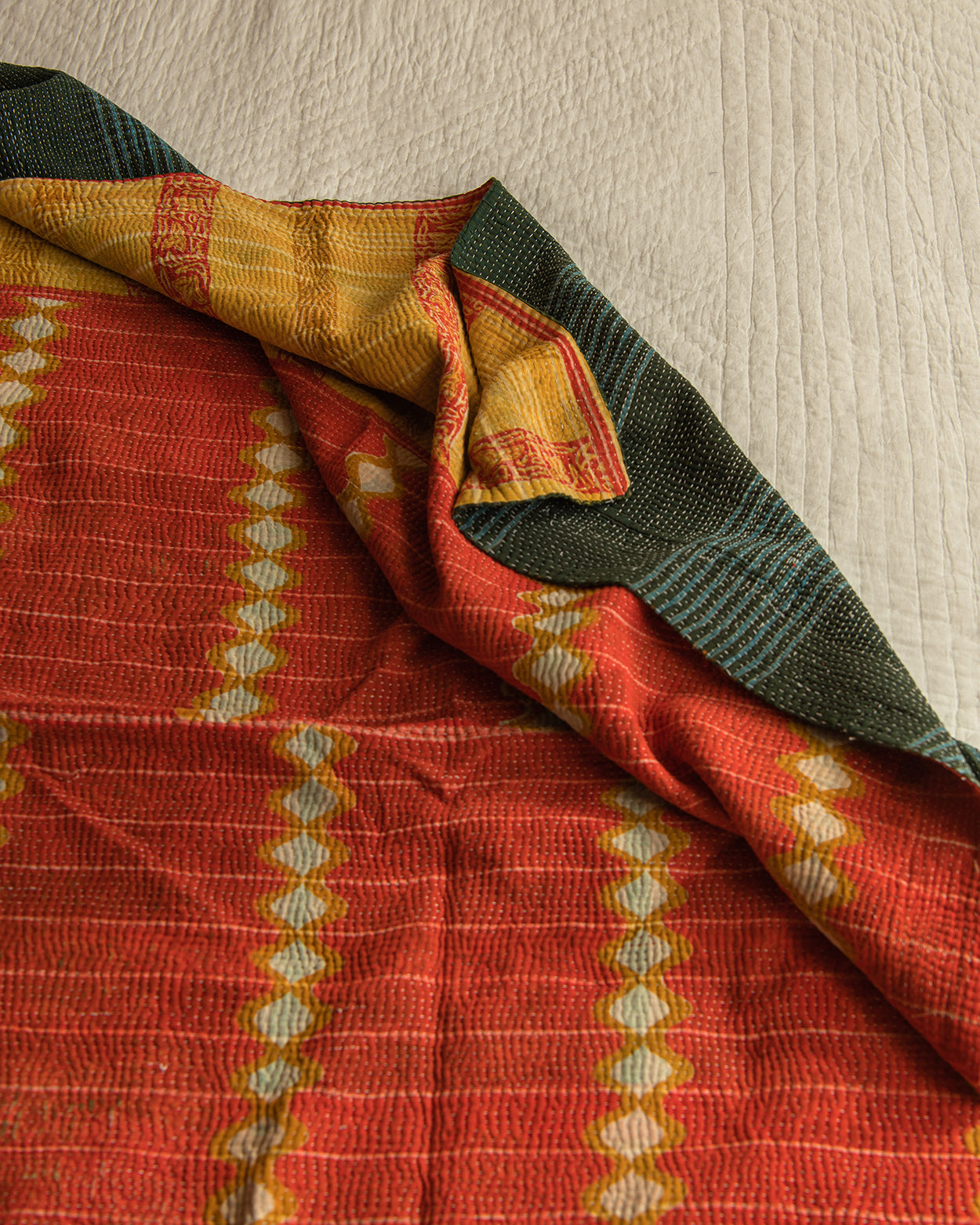 Orange Ikat with blue check reverse kantha quilt