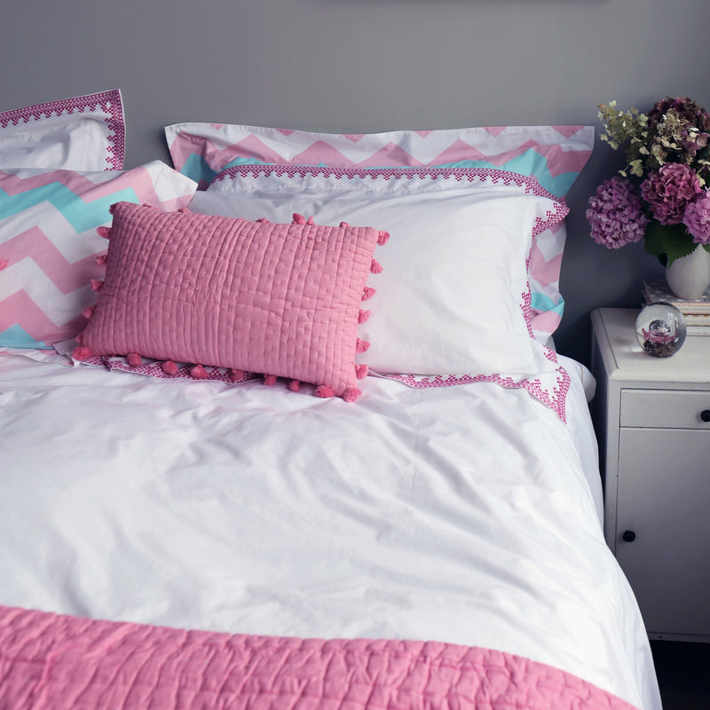 Pink pompom quilted cushion