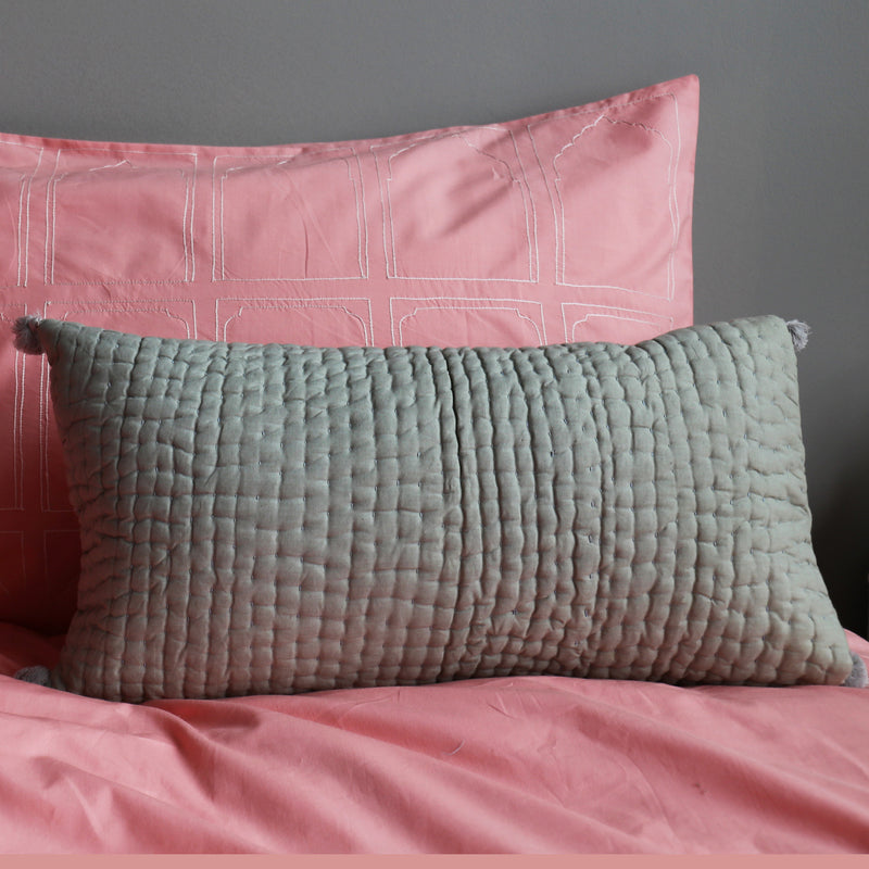 Grey pompom quilted cushion